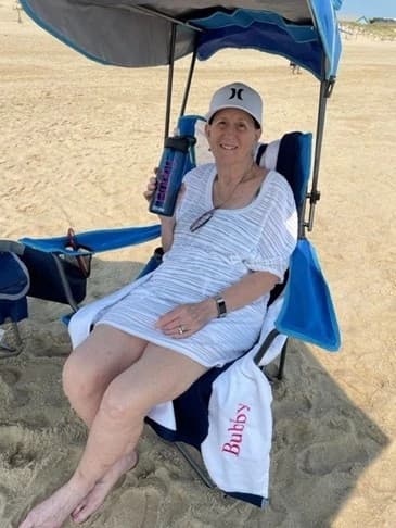 Close-up of hands gently holding a pink rose symbolizing faith and hope